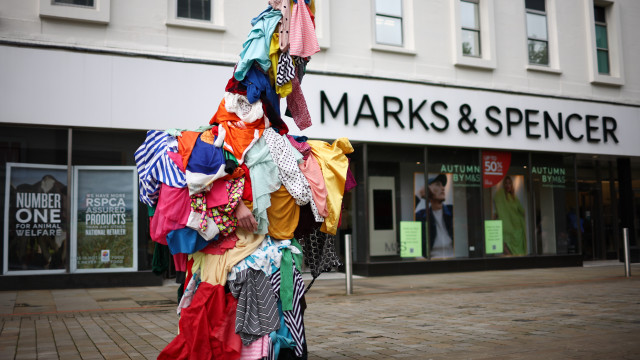 Artist Jeremy Hutchison wearing a `fast-fashion zombie` costume made of used garments from second-hand clothing markets in West Africa